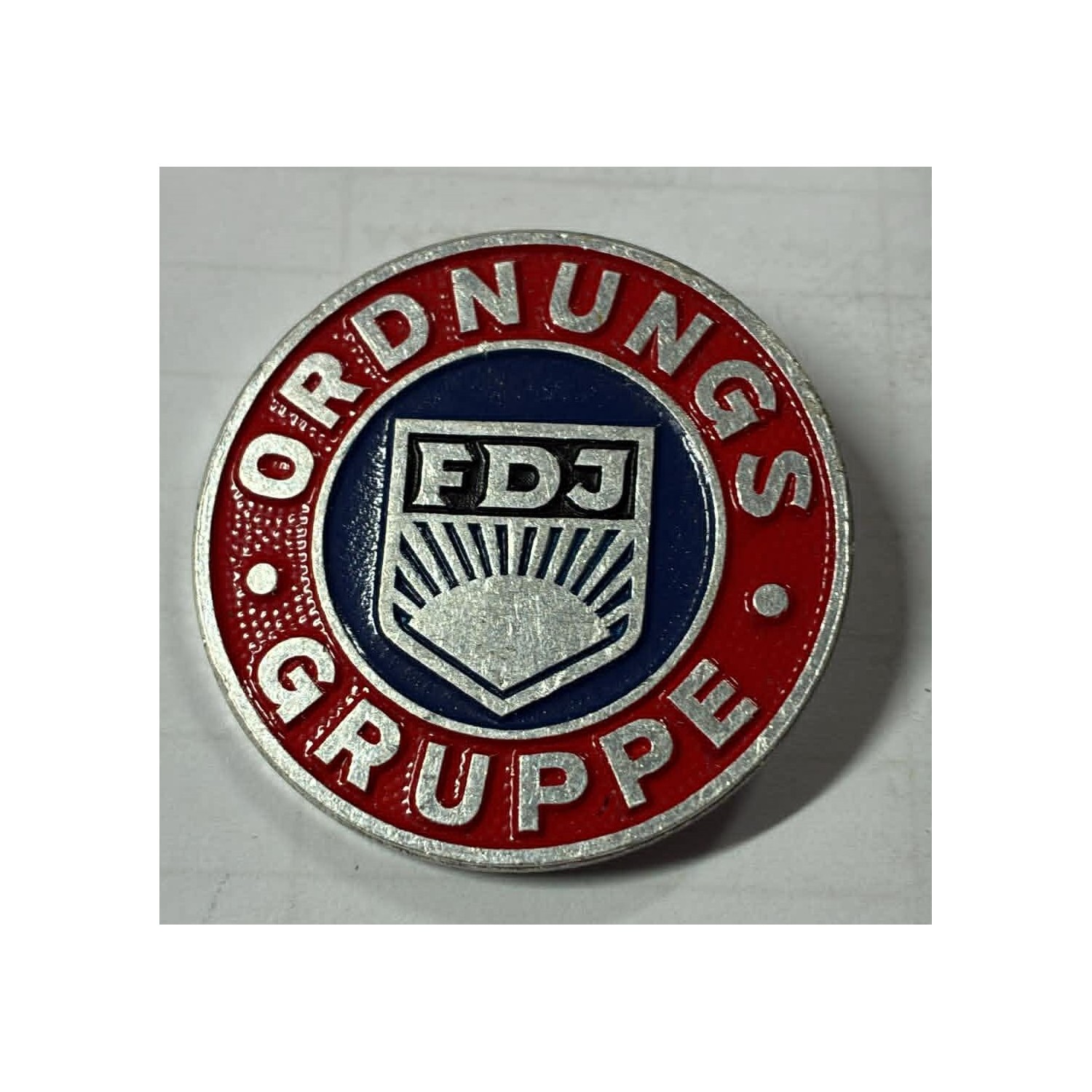 Vintage pin of the paramilitary groups "Ordnungsgruppe" of the FDJ (Freie Deutsche Jugend)