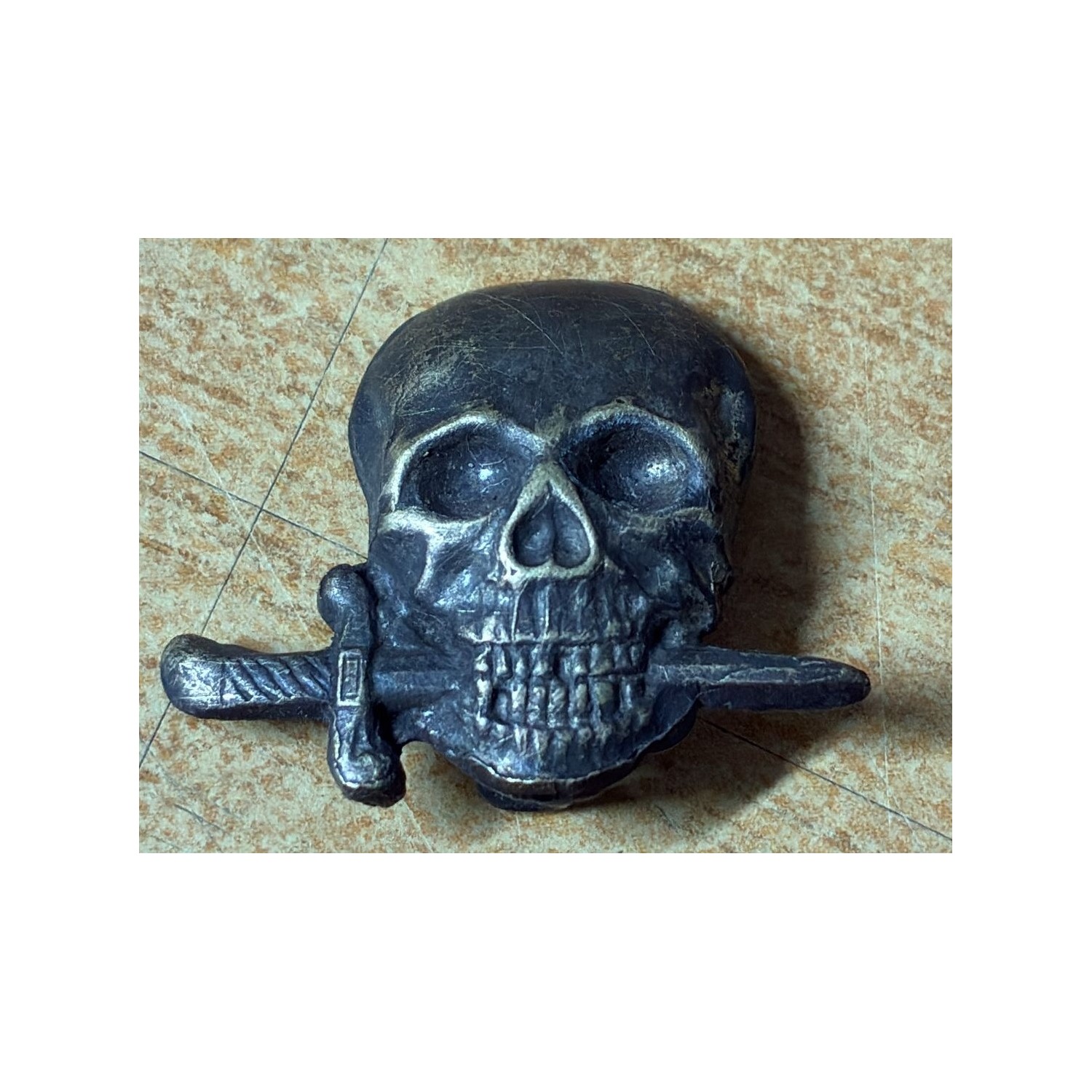 Sheet metal skull from the shoulder strap of the Black Brigades of the RSI, Italian Social Republic.