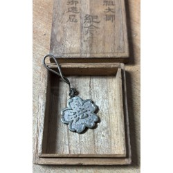 Japanese military pendant dating back to World War II, sometimes associated with Buddhist beliefs.